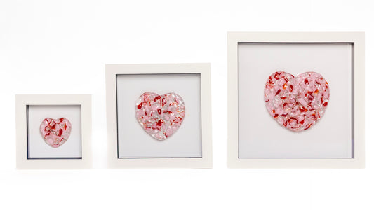 Fused glass hearts of different colours and sizes, framed